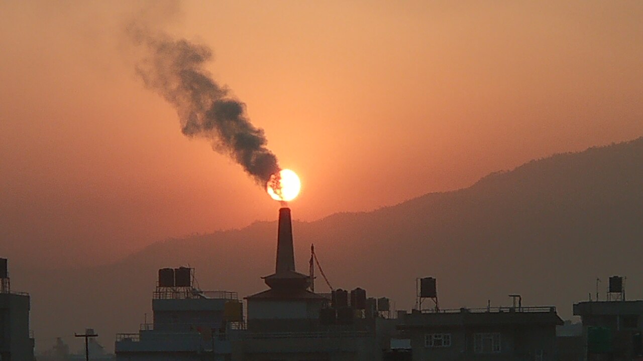 Dark smoke pours from a factory and dirties the air we breathe.