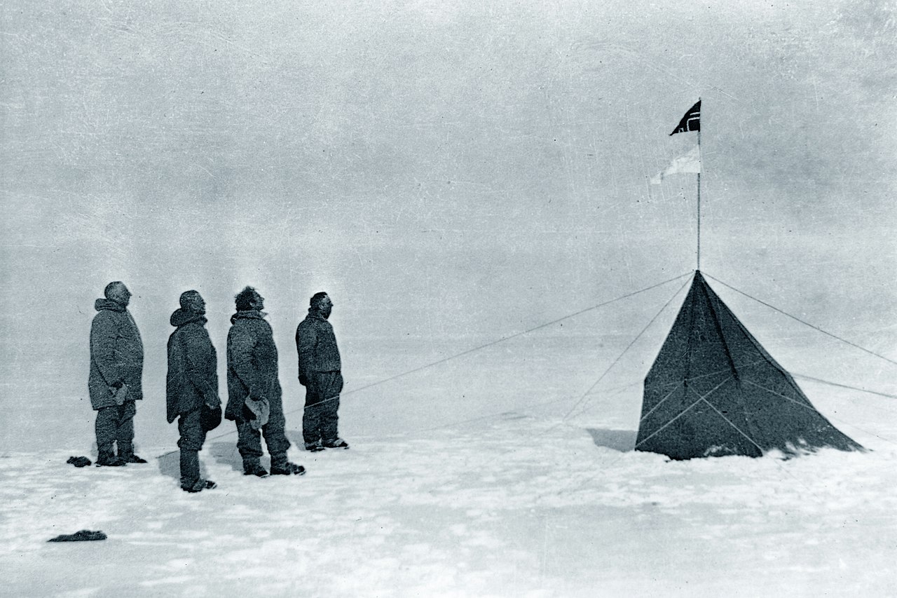 Brave explorers stand at the South Pole after their long journey.