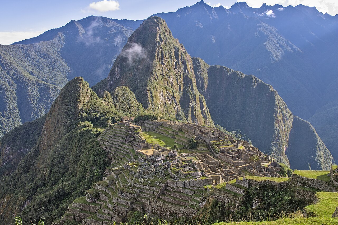 The stone city of Machu Picchu high on a green mountain.