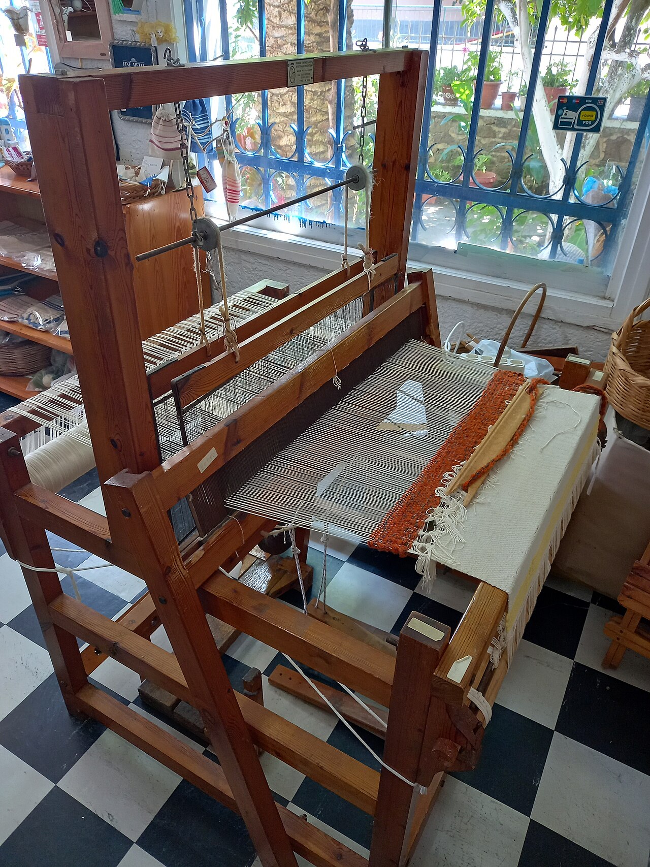 A wooden loom used for weaving cloth by hand.