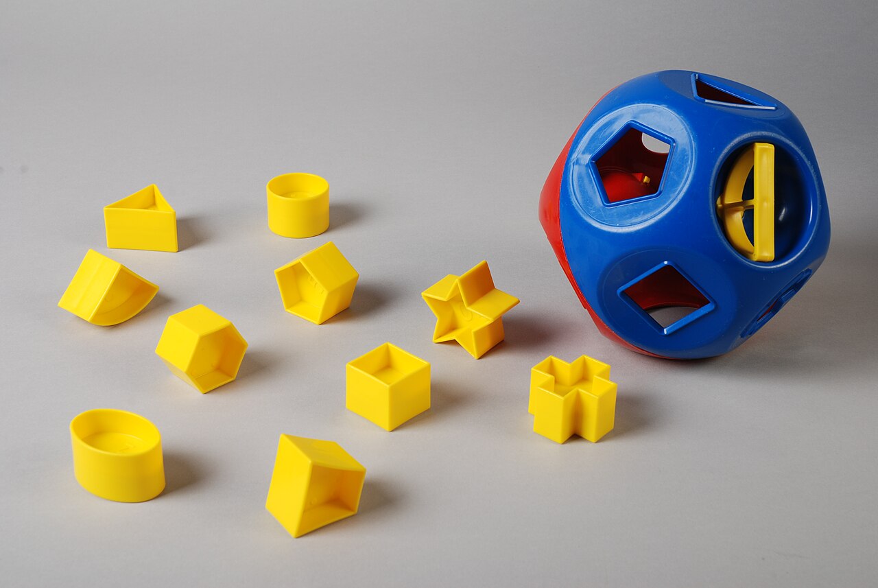 A fun shape sorter toy where kids match shapes into holes.